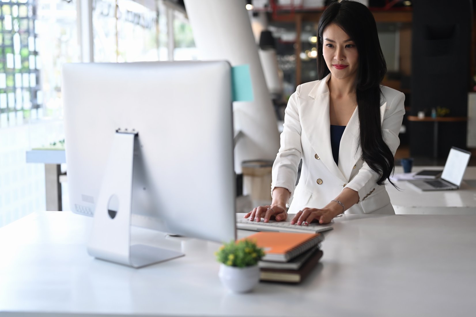 Confident Business Woman Using Computer Searching for Business D